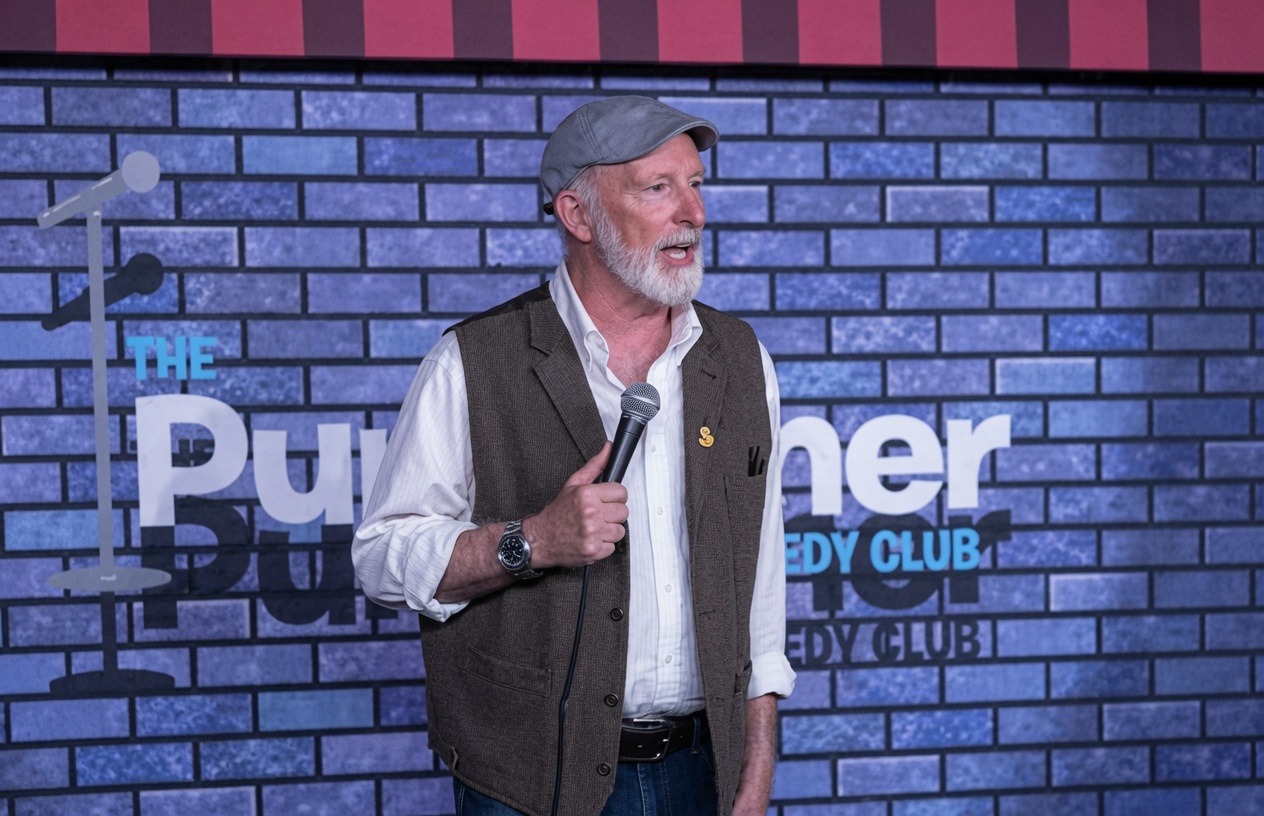 Paul Lyons performing stand-up at The Punchliner Comedy Club